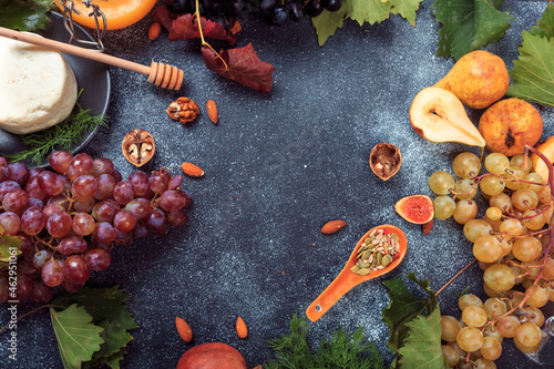 Mediterranean snacks - grapes, olives, bread, fruit, seeds - Image