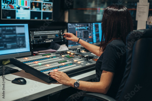 Young beautiful woman working in a broadcast control room on a tv station Fototapet