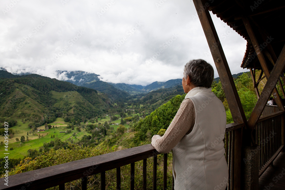 Senior woman at the beautiful view point over the Cocora Valley in Salento, located on the region of Quindio in Colombia