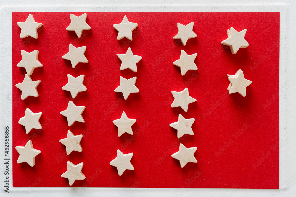 wooden stars on red and white paper background
