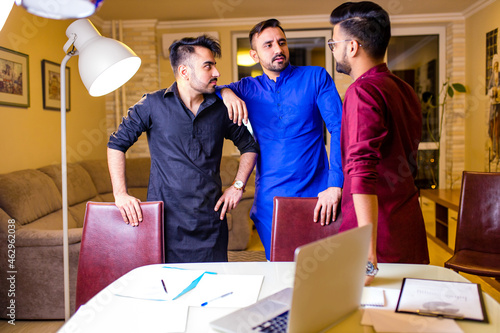 indian people talking in living room in evening meeting photo