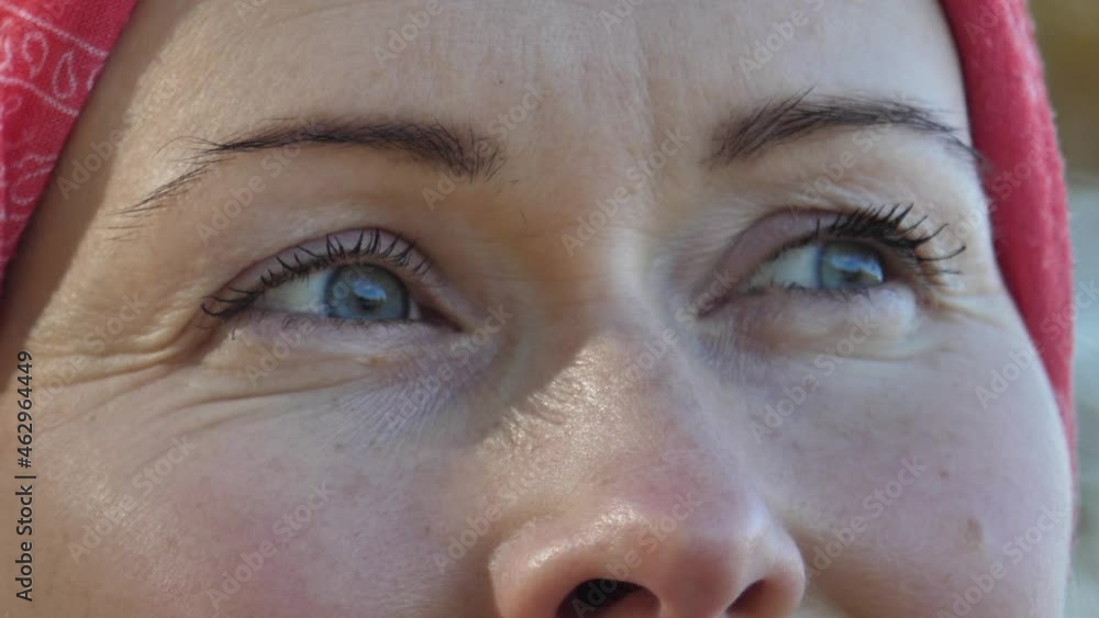 A woman with beautiful eyes from the side. Sunlight shines on the lens A woman with beautiful eyes from the side. Sunlight shines on the lens
