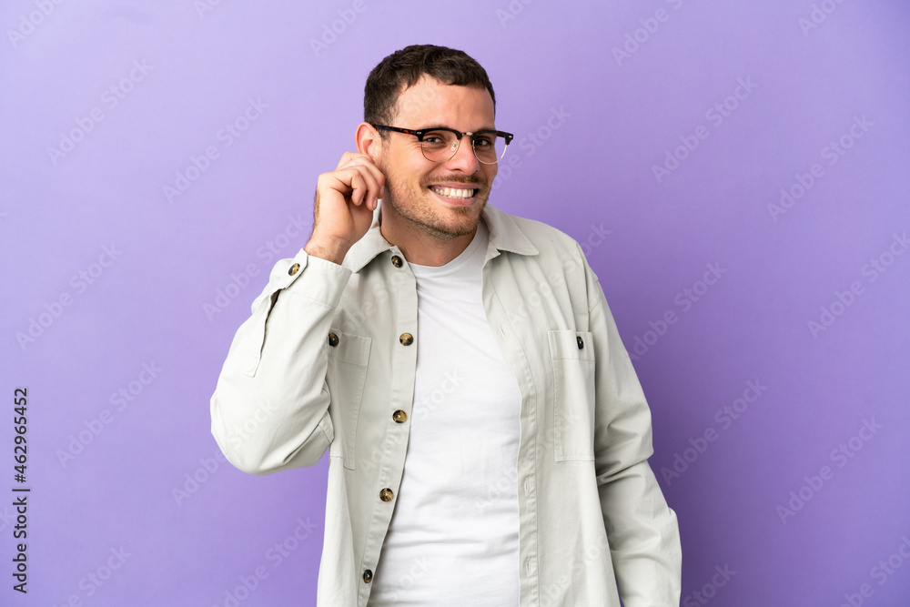 Brazilian man over isolated purple background laughing Brazilian man over isolated purple background laughing