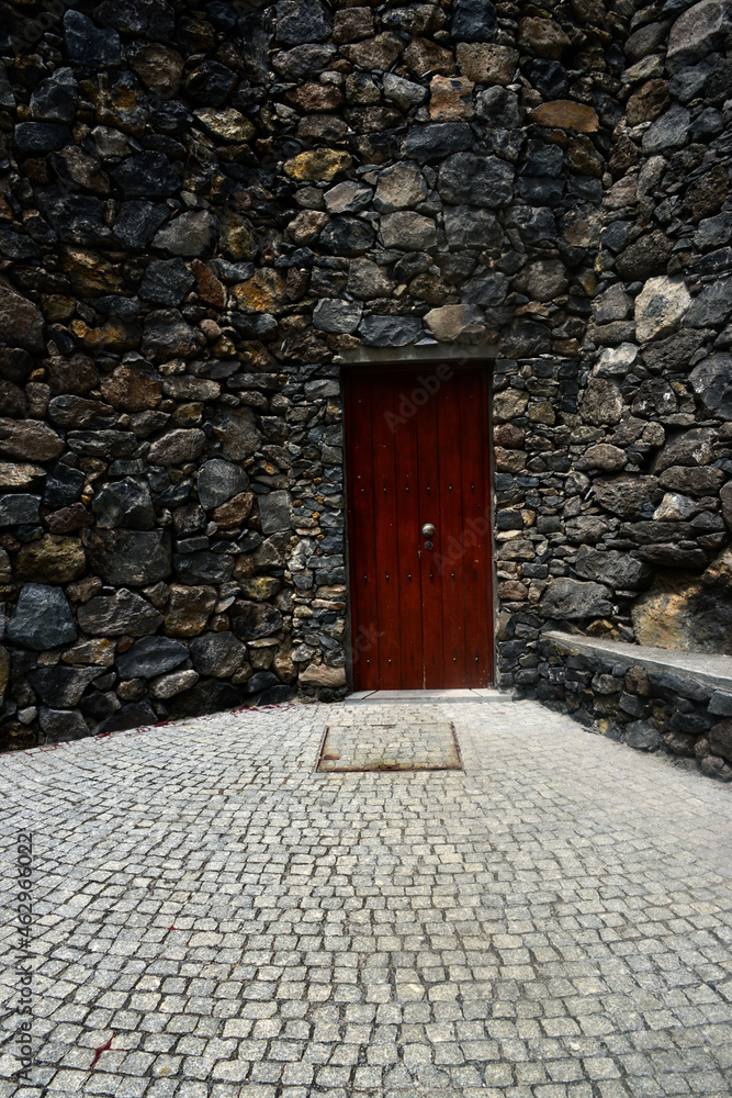 red door and old stone wall