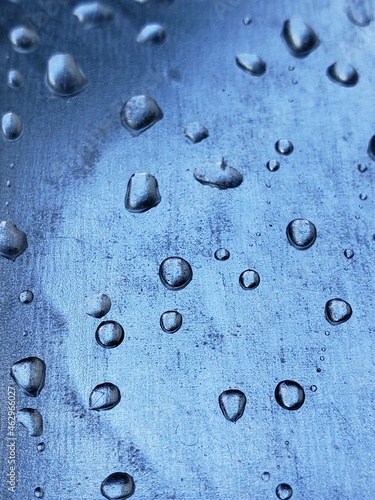 water droplets on a metal plate with holes, close-up. Macro photo