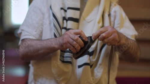 An adult man, a Jew, folding tefillin. photo