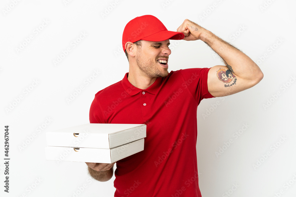 pizza delivery man with work uniform picking up pizza boxes over isolated white wall celebrating a victory pizza delivery man with work uniform picking up pizza boxes over isolated white wall celebrating a victory