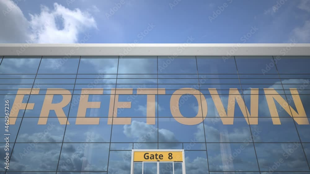 FREETOWN city name and landing airplane at airport terminal FREETOWN city name and landing airplane at airport terminal