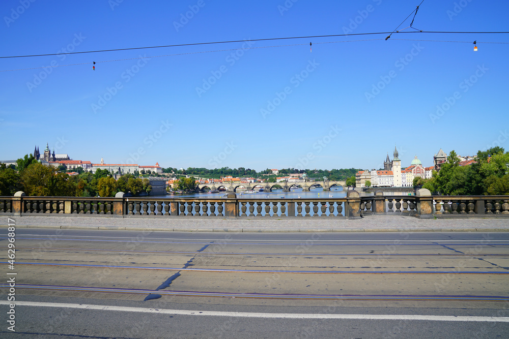 Palacky Bridge with tramlines and cables overlooking Vltava River and city skyline