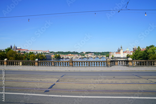 Palacky Bridge with tramlines and cables overlooking Vltava River and city skyline photo