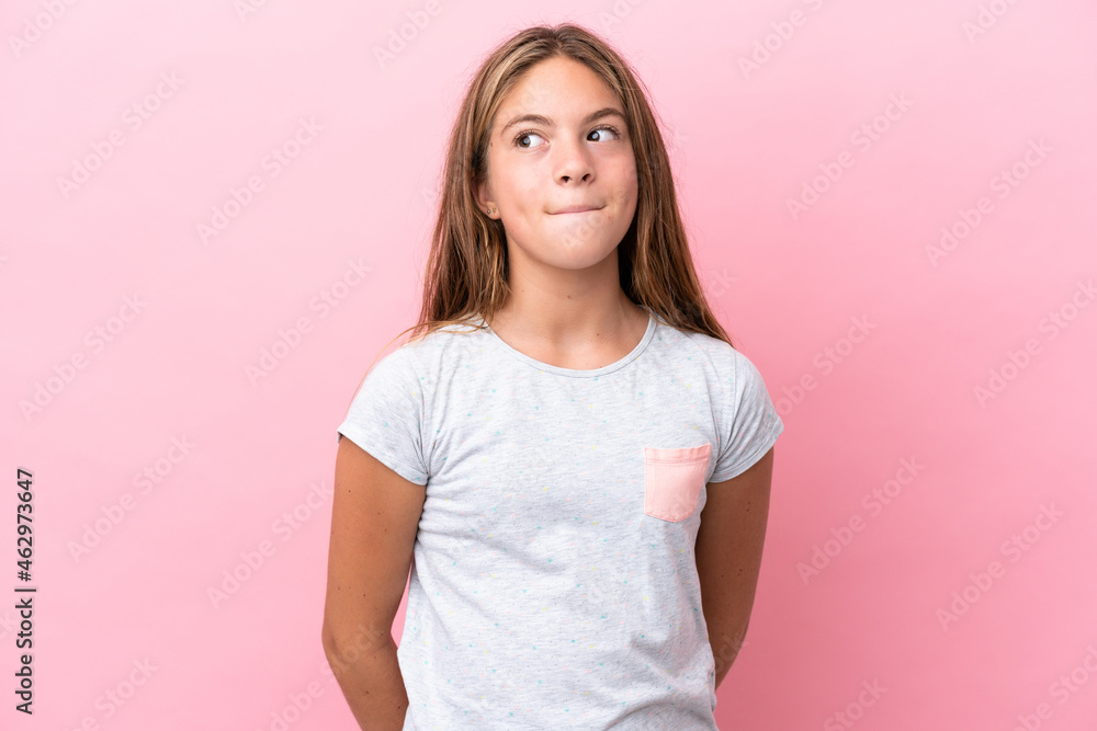Little caucasian girl isolated on pink background having doubts while looking up Little caucasian girl isolated on pink background having doubts while looking up