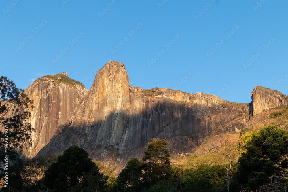 Panorama of the stone wall of the Torres de Bonsucesso mountain range, composed of three tall towers, located in the Três Picos State Park (PETP), Teresopolis, Rio de Janeiro, Brazil
