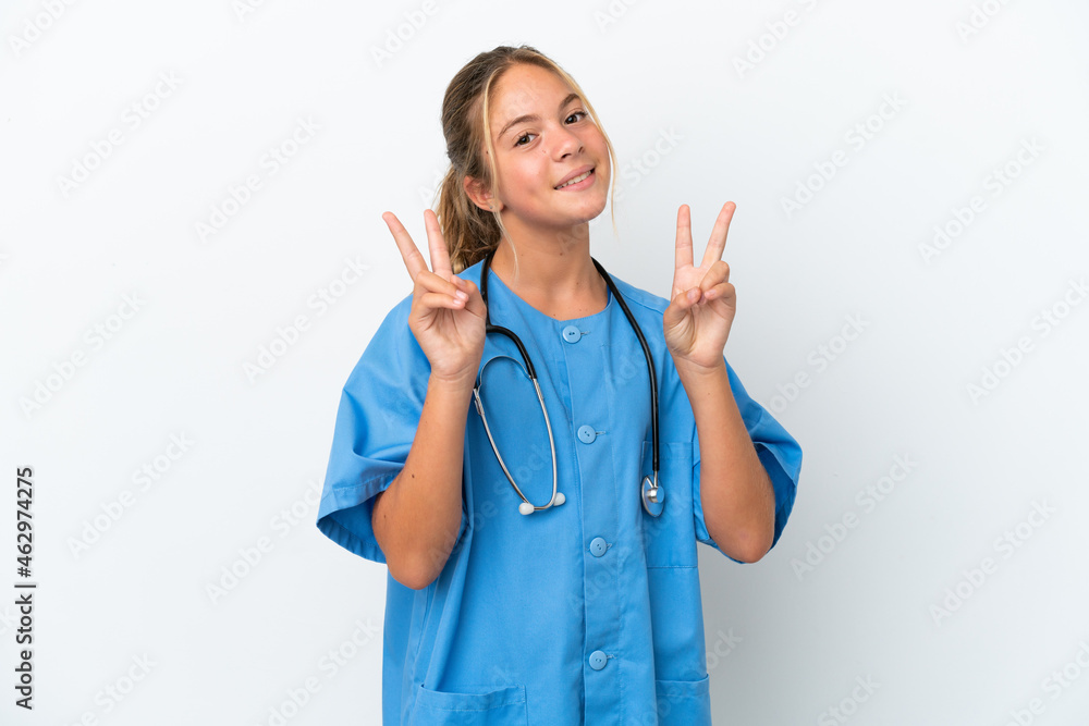 Little caucasian girl disguised as surgeon isolated on white background showing victory sign with both hands