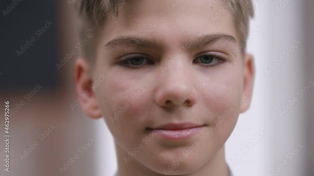 Headshot portrait of smiling confident teenage Caucasian boy looking at camera. Close-up happy face of charming handsome teenager posing indoors. Confidence and lifestyle concept Headshot portrait of smiling confident teenage Caucasian boy looking at camera. Close-up happy face of charming handsome teenager posing indoors. Confidence and lifestyle concept