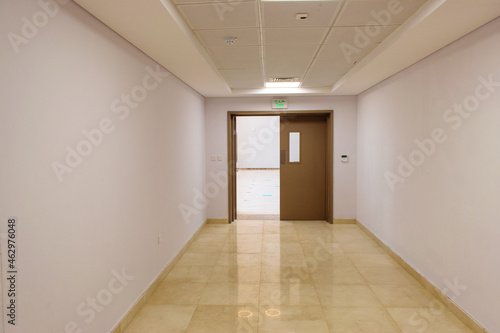 hallway with celling and double door half open
