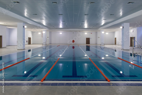 Empty Olympic swimming pool with clear blue water