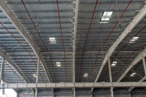 Metal warehouse roof interior with fire equipment 