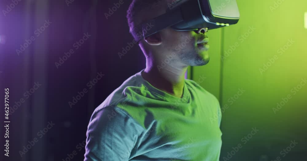 African american male computer technician using vr headset working in business server room African american male computer technician using vr headset working in business server room