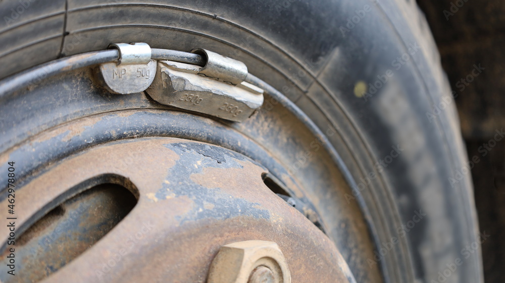 Lead weight on the wheel rim. Wheel balancing weights to balance the vehicle with the copy space. Close focus and select the subject