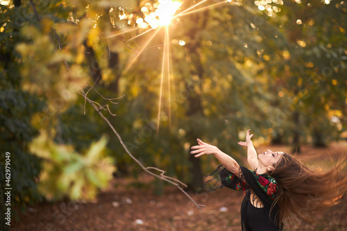 Bild auf Leinwand Pagan ritual, young witch summoning spirits of the forest on halloween