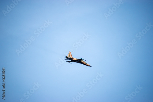 A single desert painted T-38 talon flying overhead photo