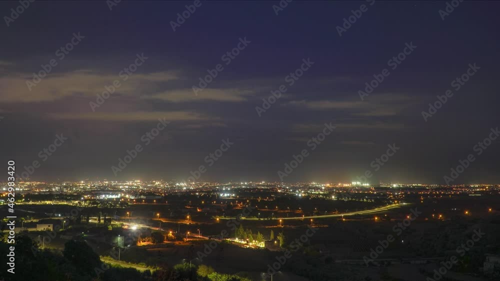 Night timelapse of city scape with lightening in the background Night timelapse of city scape with lightening in the background