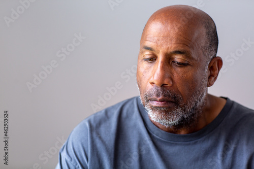 Portrait of a mature man looking sad and away from the camera.