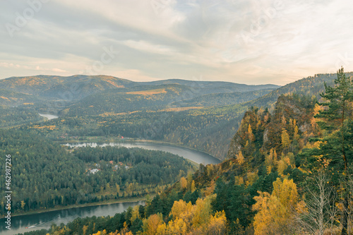 River valley on the background of beautiful mountains in autumn. Bird`s-eye view.