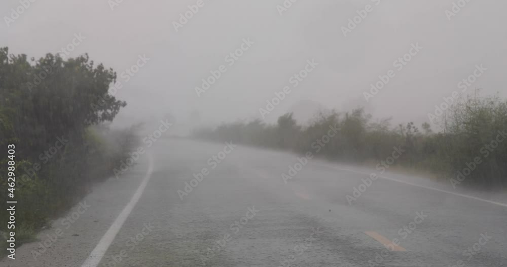 Heavy Downpour of Rain During Monsoon Season Along the Roadside in the Countryside of Thailand. Heavy Downpour of Rain During Monsoon Season Along the Roadside in the Countryside of Thailand.