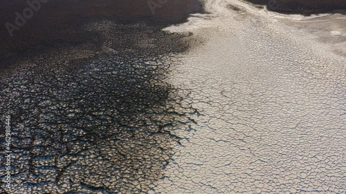 Cracks and crevices of dry, arid and raw salt pans at Badwater basin floor of Death Valley National Park. 