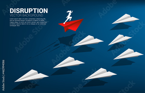 Silhouette of businesswoman running on red origami paper airplane go different way from group of white. Business Concept of disruption and vision mission.