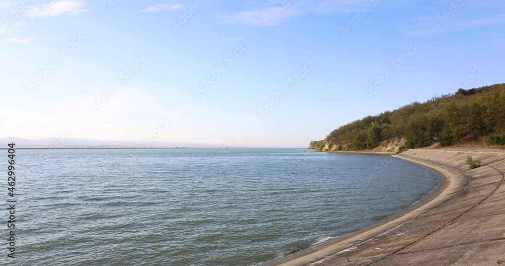 Distant View Of Tourists At The Waterfront Of The River Under Moving Clouds At Daytime. time lapse Distant View Of Tourists At The Waterfront Of The River Under Moving Clouds At Daytime. time lapse