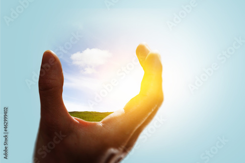 Sky and clouds in human hand