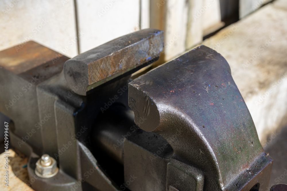 Oblique angle shot of a vise outdoors, taken from an angle. Oblique angle shot of a vise outdoors, taken from an angle.
