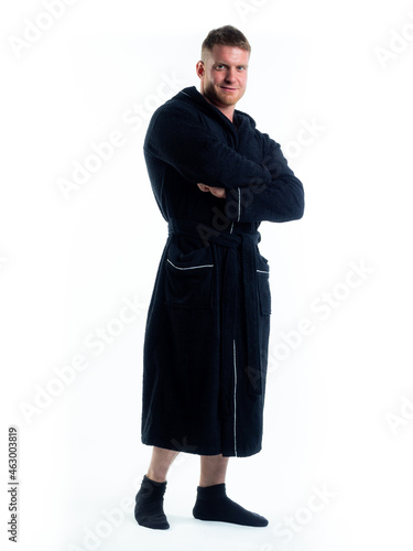 strong man in a Bathrobe on an isolated white background with a smile on his face.