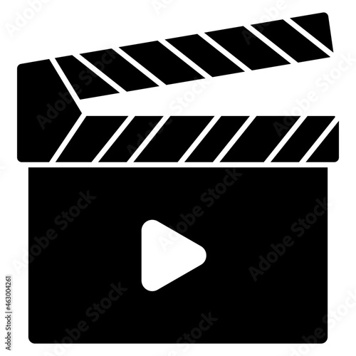 A solid design icon of clapperboard 