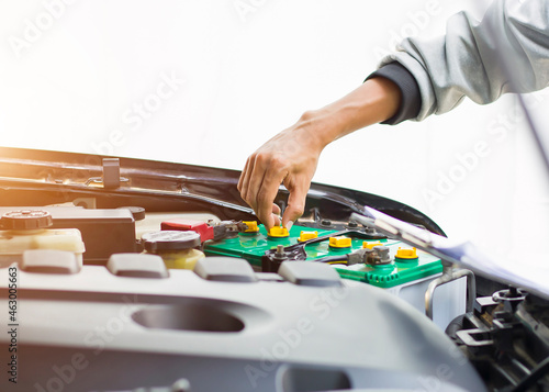 Technicians inspect the car's electrical system.