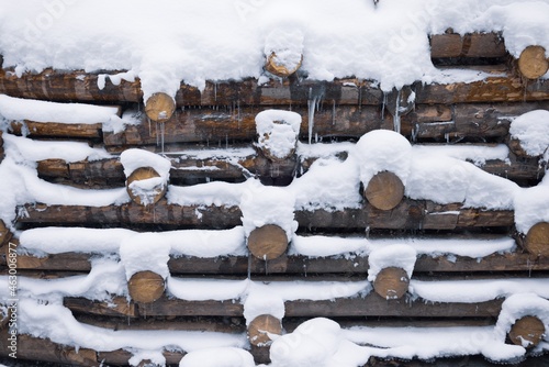 Strengthening of logs, wooden wall under snow in winter