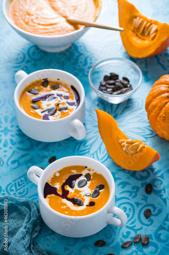 Homemade pumpkin soup with coconut milk, pumpkin oil and seeds