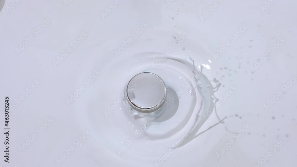 Cosmetic jar with pouring water and template on white background cosmetic ads template for cosmetic brands body care health concept. top view Cosmetic jar with pouring water and template on white background cosmetic ads template for cosmetic brands body care health concept. top view