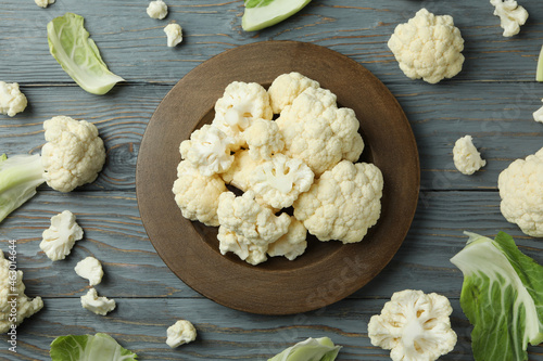 Concept of tasty food with cauliflower on wooden background