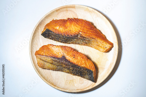 Salmon steak on the wooden dish.