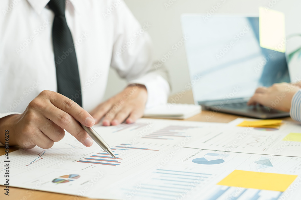 Two business leaders talk about charts, financial graphs showing results are analyzing and calculating planning strategies, business success building processes Two business leaders talk about charts, financial graphs showing results are analyzing and calculating planning strategies, business success building processes