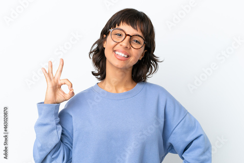 Young mixed race woman isolated on white background With glasses and doing OK sign