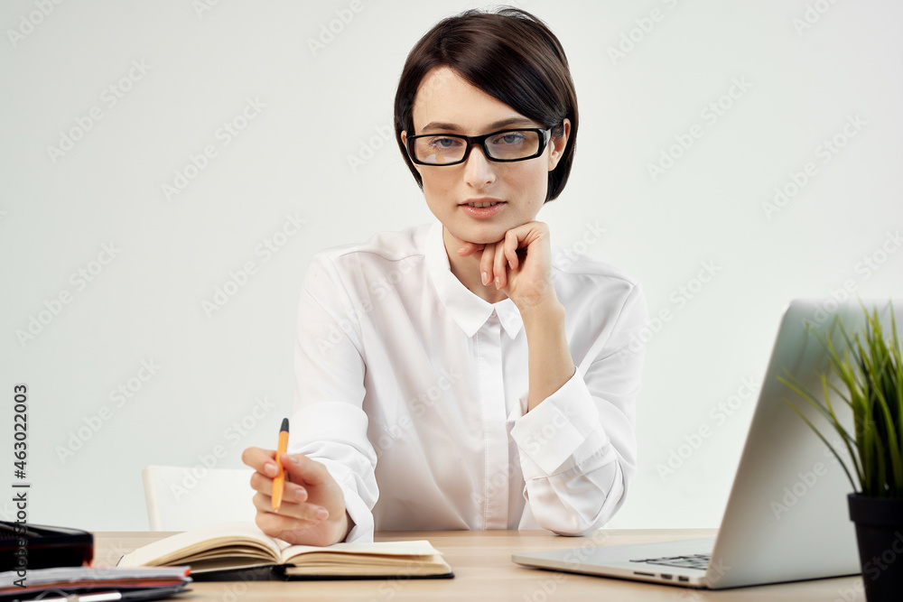 woman in costume in front of laptop documents Professional Job light background woman in costume in front of laptop documents Professional Job light background