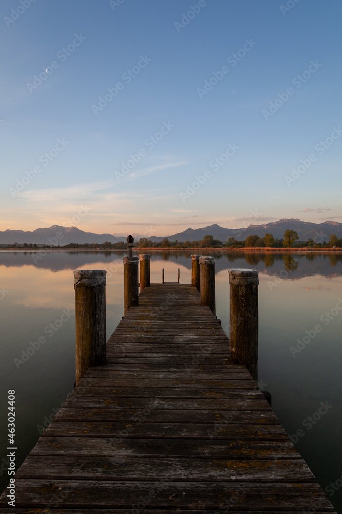 Sunrise over the Chiemsee with an old pier in the water Sunrise over the Chiemsee with an old pier in the water