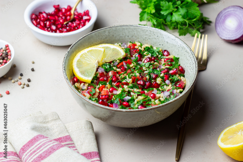 Tabbouleh salad with bulgur, mint, parsley, tomatoes and pomegranate. Healthy eating. Vegetarian food. Tabbouleh salad with bulgur, mint, parsley, tomatoes and pomegranate. Healthy eating. Vegetarian food.