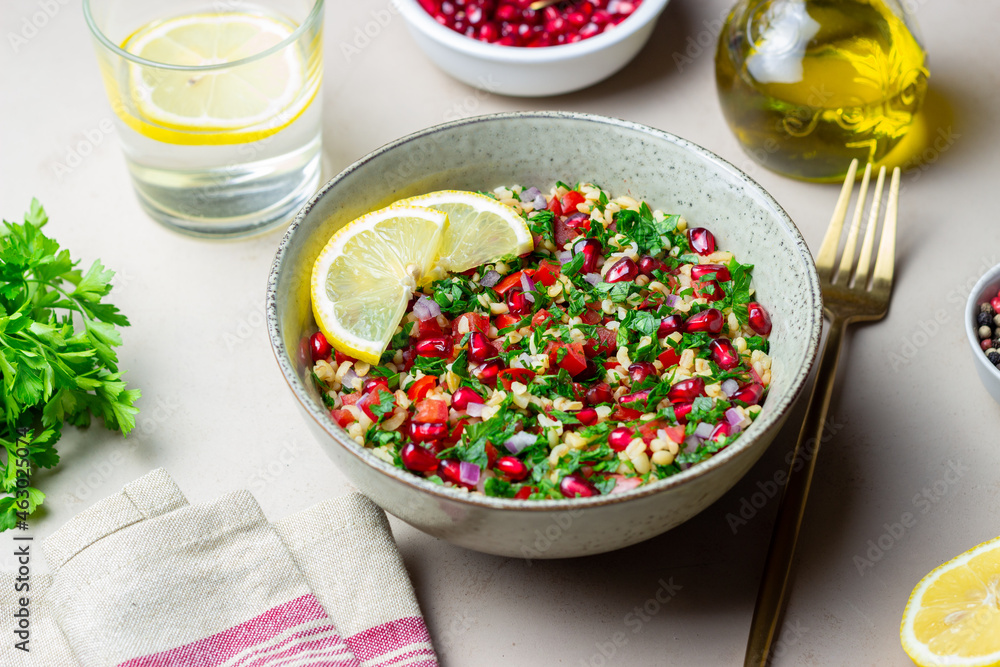 Tabbouleh salad with bulgur, mint, parsley, tomatoes and pomegranate. Healthy eating. Vegetarian food. Tabbouleh salad with bulgur, mint, parsley, tomatoes and pomegranate. Healthy eating. Vegetarian food.