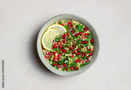 Tabbouleh salad with bulgur, mint, parsley, tomatoes and pomegranate. Healthy eating. Vegetarian food.