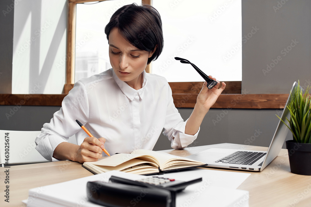 woman in costume in front of laptop Secretary executive light background woman in costume in front of laptop Secretary executive light background